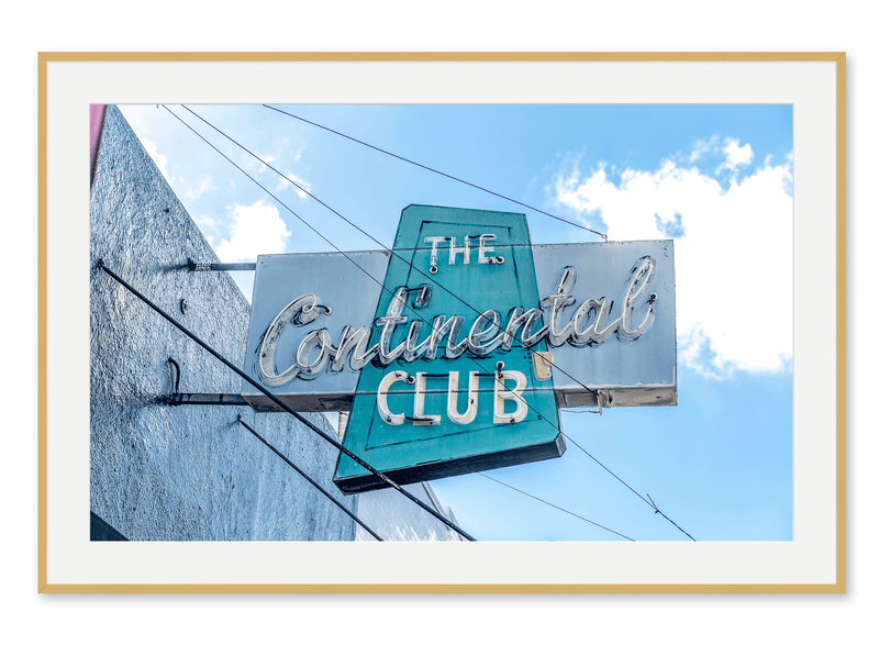 Neon blue and aqua sign hanging outside The Continental Club