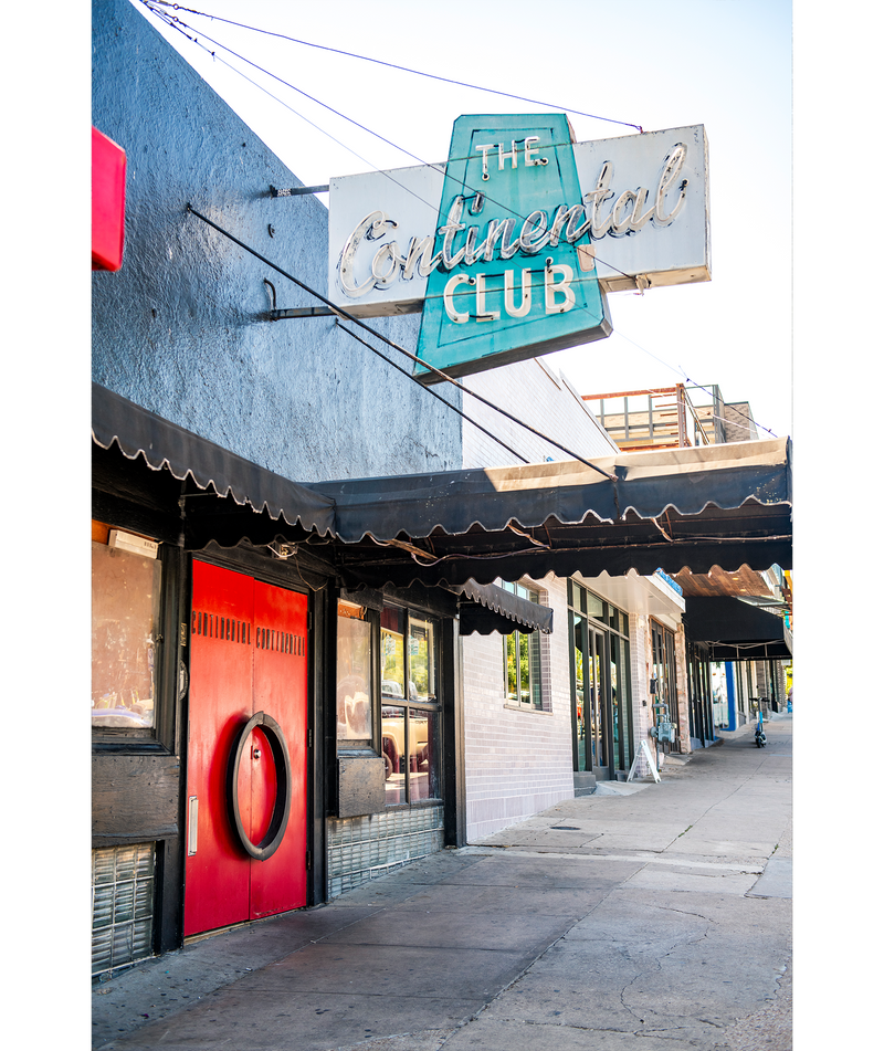 Bright red doors and a blue neon sign mark the entrance to The Continental Club