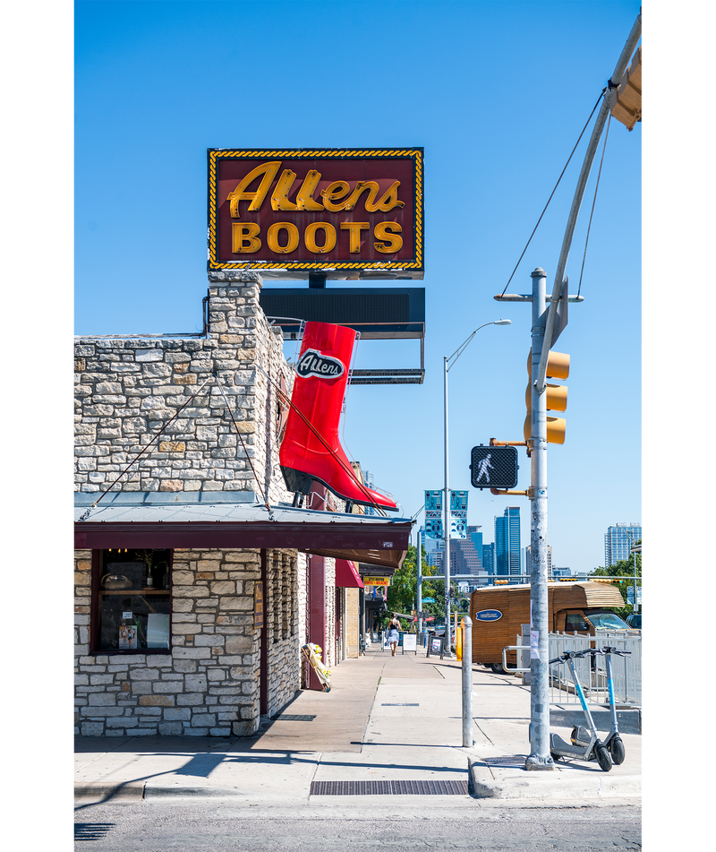 A big red boot sign hangs outside Allens Boots on South Congress Avenue