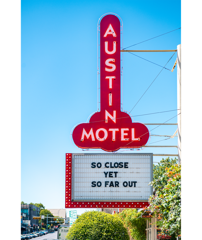 Austin Motel sign reads "so close yet so far out"