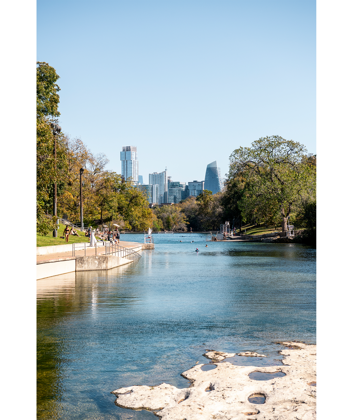 Swimmers enjoy the sunny day at Barton Springs Pool