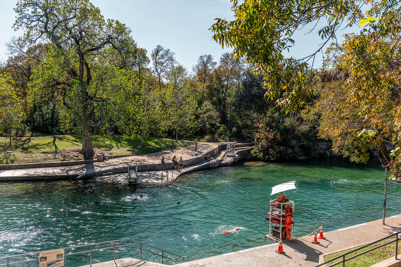 A lifeguard watches over swimmers at Barton Springs Pool