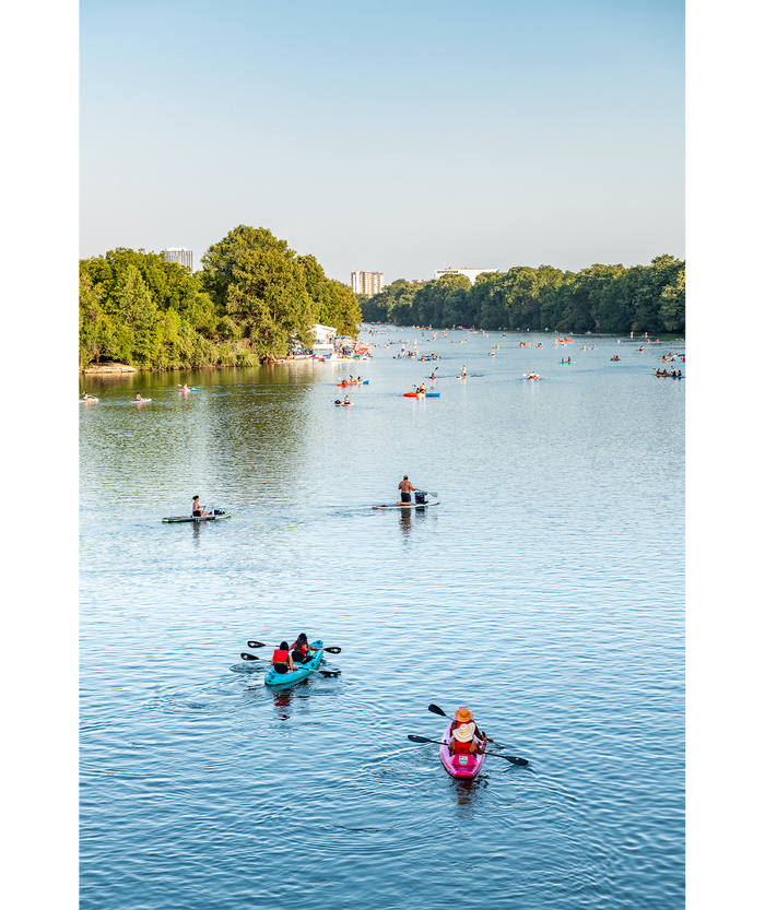 Kayakers and paddle boarders on Lady Bird Lake