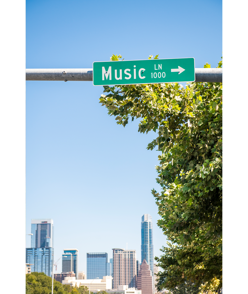 The Music Lane sign on South Congress Avenue hangs in front of the Austin skyline