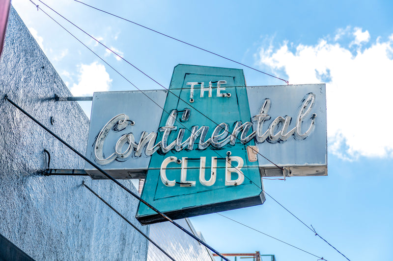 blue and turquoise neon Continental Club sign